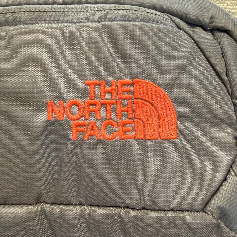 The North Face Gray and Black Backpack with Orange Logo